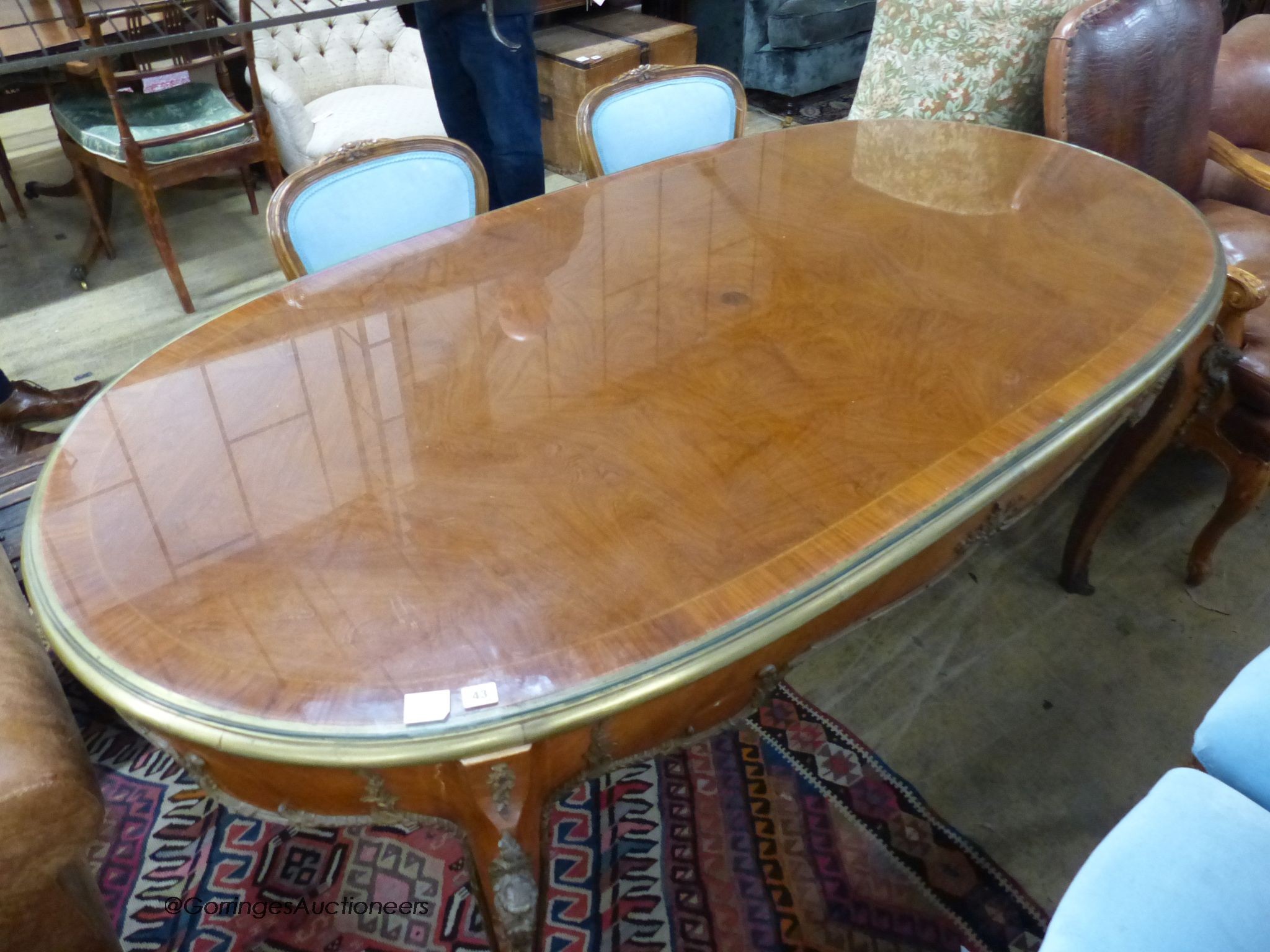 An oval gilt metal mounted Continental dining table, length 200cm, width 100cm, height 78cm